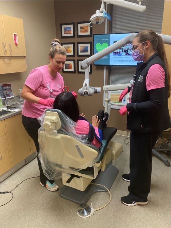 A Village Dental clinician training a colleague chairside